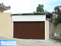 Sectional overhead garage door with wood patterned flush panel